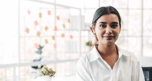Business person with a whiteboard behind them in a modern office