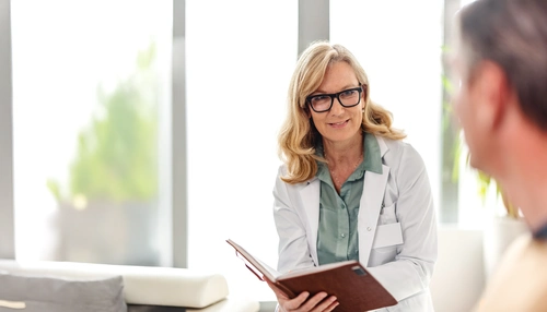 Doctor discussing illness with patient in an office