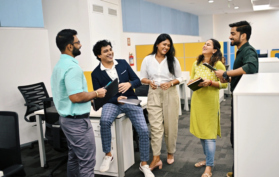 Group of five business people in India discussion and laughing