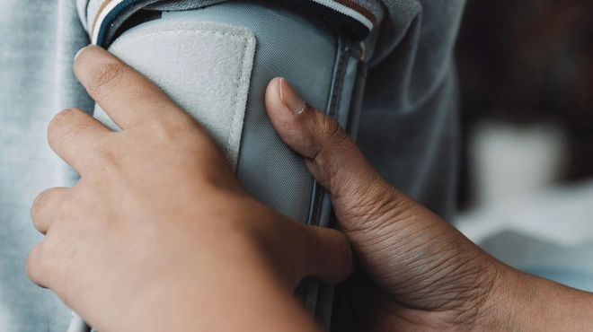 Healthcare professional uses blood pressure cuff on patient