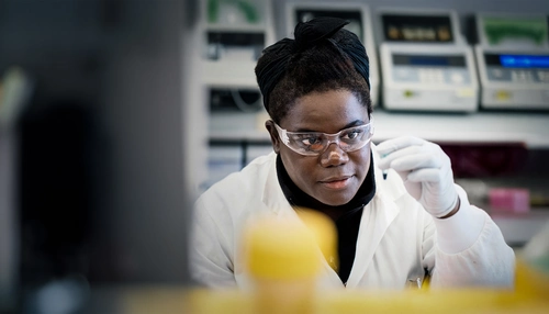 Research scientist in a lab looking at a sample